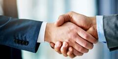 Two people shaking hands in greeting