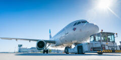 Passenger aircraft on the apron with ground handling vehicles